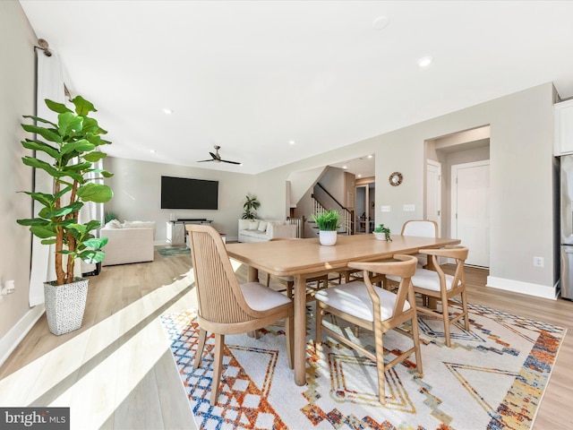 dining area featuring stairs, recessed lighting, light wood-style flooring, and baseboards