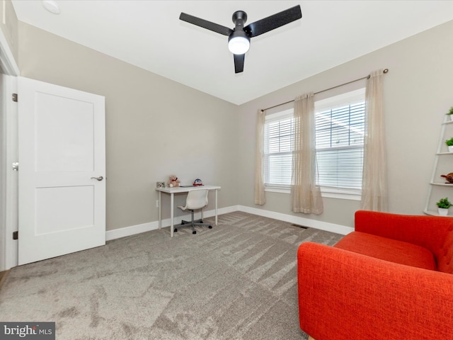 carpeted office space featuring a ceiling fan, visible vents, and baseboards