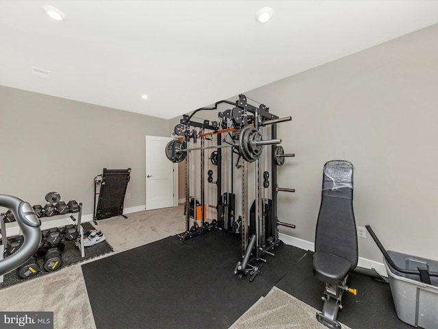 exercise room with recessed lighting and baseboards