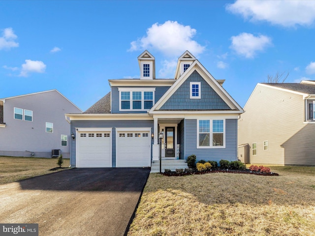 view of front of property featuring a front yard, driveway, and central air condition unit