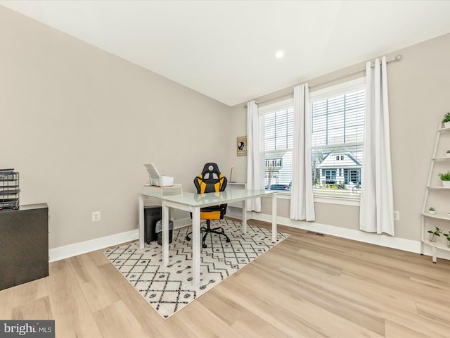 office featuring visible vents, baseboards, and wood finished floors