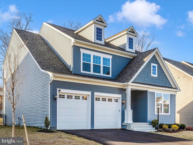 view of front of property with aphalt driveway, roof with shingles, and an attached garage