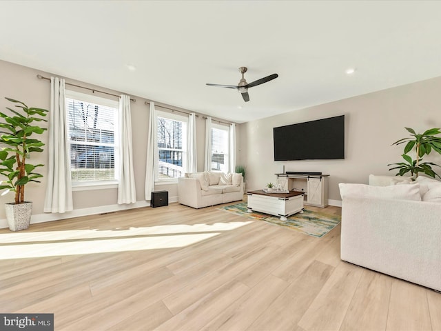 living area with light wood-style floors, recessed lighting, ceiling fan, and baseboards