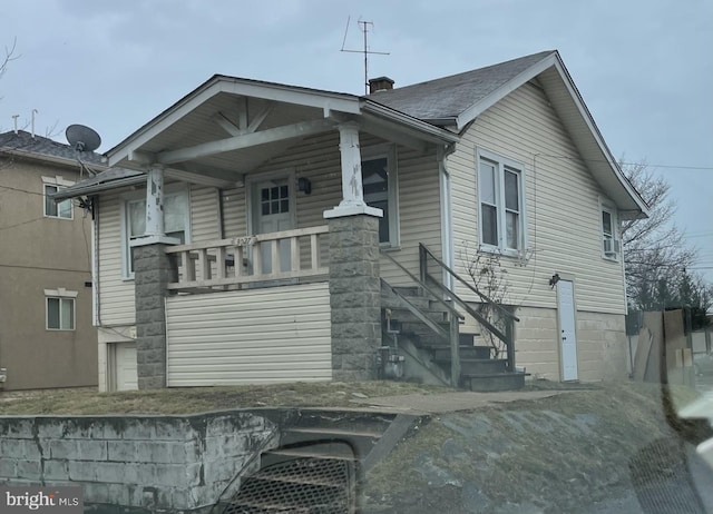 back of property featuring covered porch