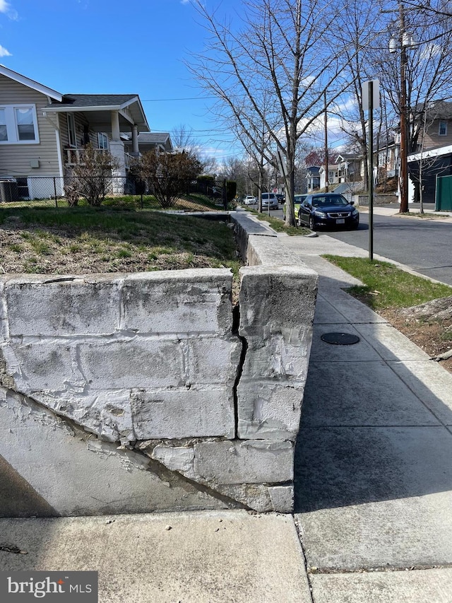 view of street featuring sidewalks, curbs, and a residential view