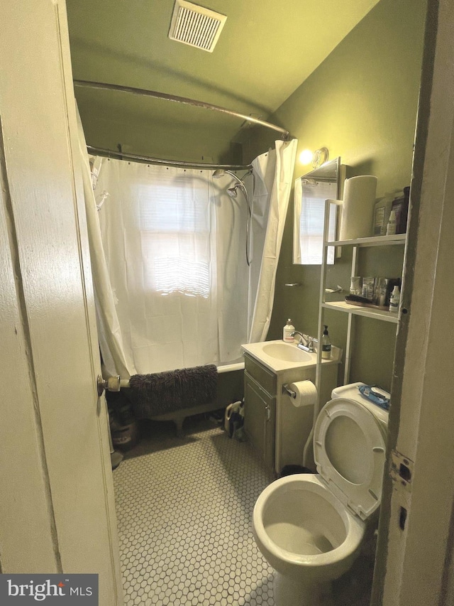bathroom featuring vanity, visible vents, tile patterned flooring, shower / bath combination with curtain, and toilet
