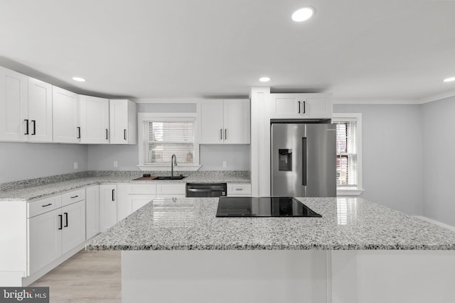 kitchen with dishwashing machine, black electric cooktop, a sink, a kitchen island, and stainless steel fridge