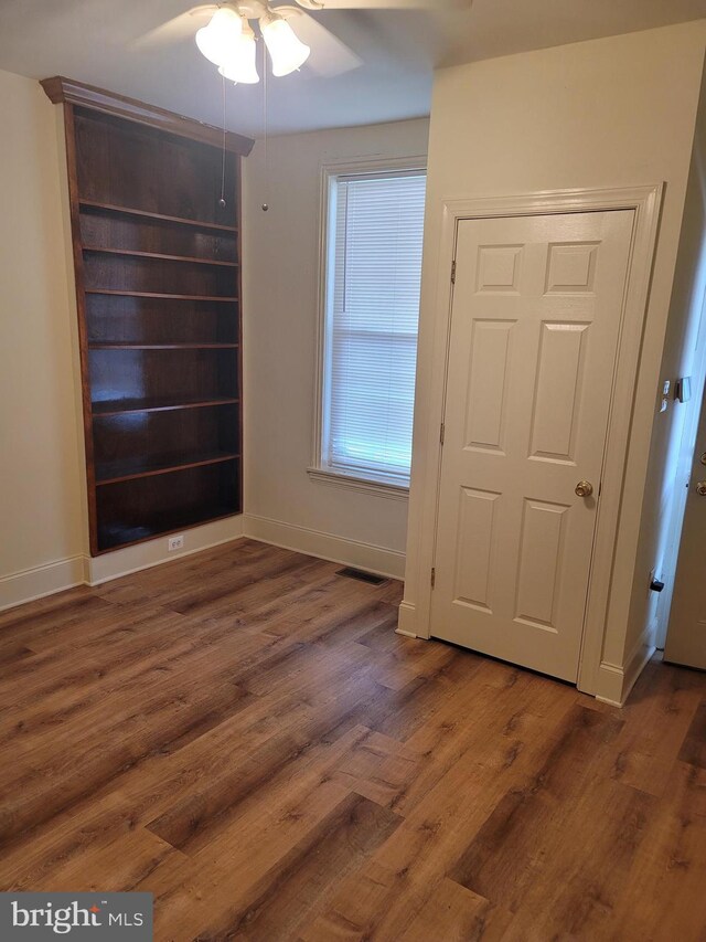 interior space with visible vents, baseboards, and wood finished floors