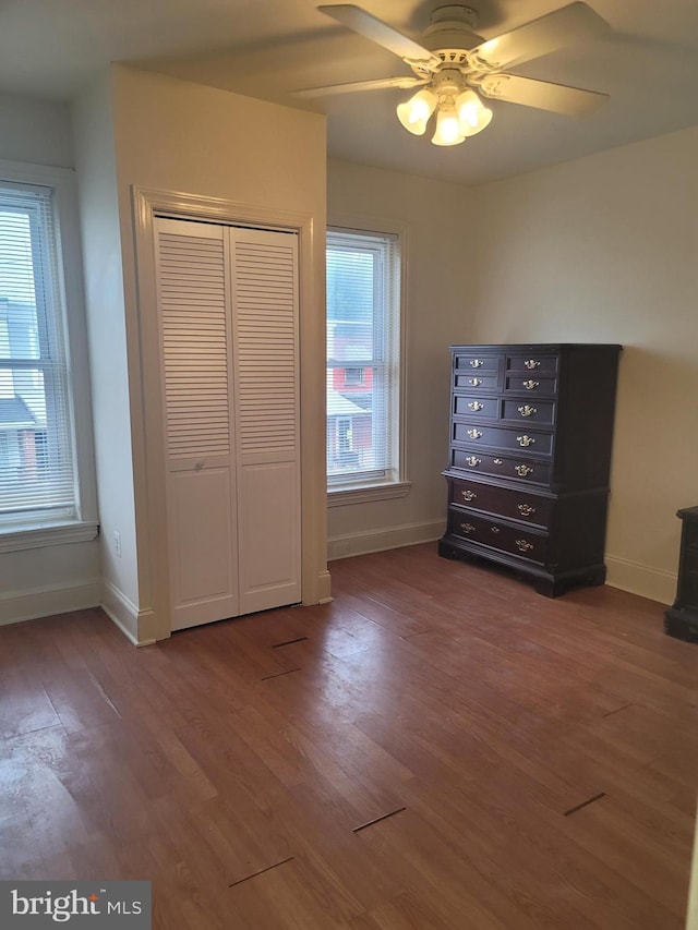 unfurnished bedroom featuring baseboards and wood finished floors