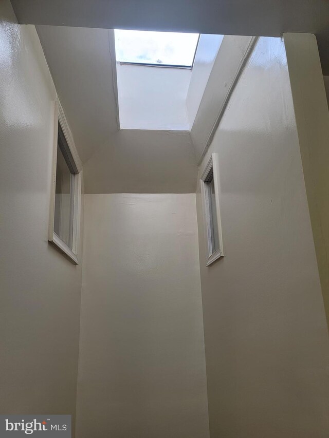 corridor featuring lofted ceiling