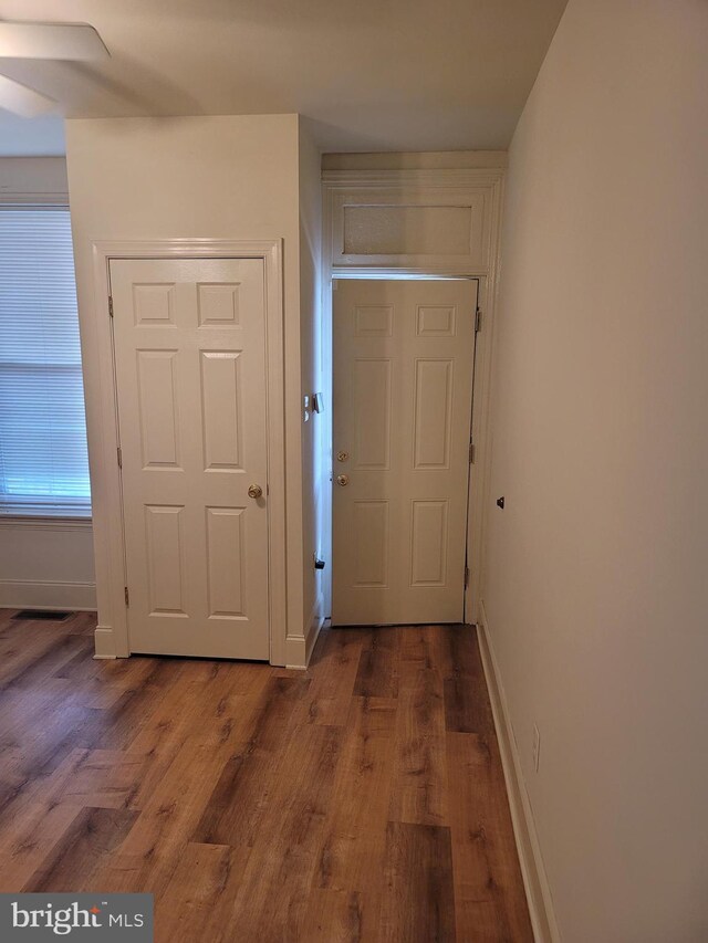 interior space featuring baseboards and wood finished floors