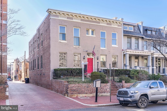 view of property featuring brick siding