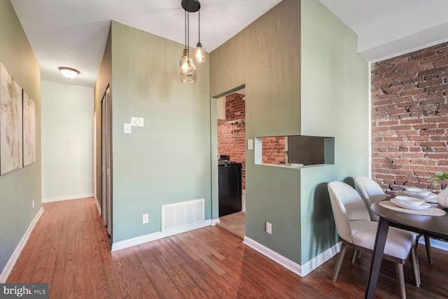 dining area with visible vents, baseboards, and wood finished floors