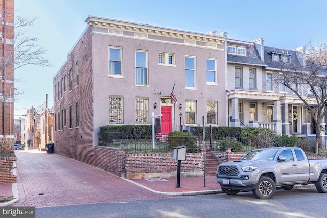 townhome / multi-family property with brick siding