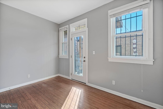 entrance foyer featuring baseboards and wood finished floors