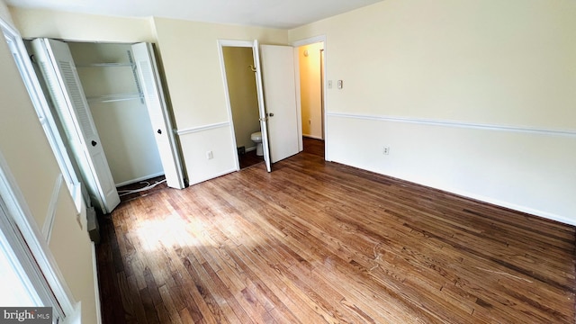 unfurnished bedroom featuring a closet and wood finished floors