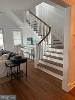 staircase featuring vaulted ceiling and wood finished floors