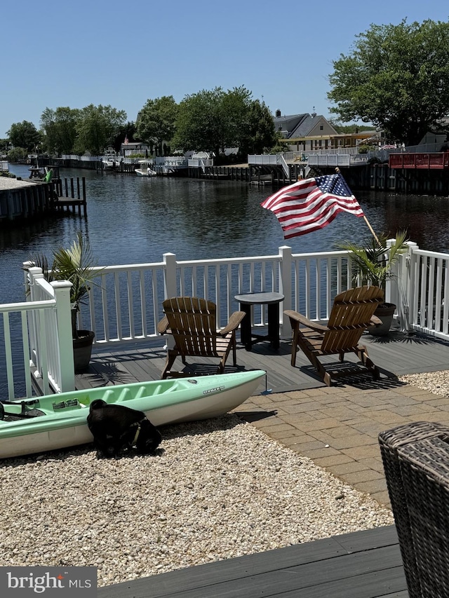 exterior space with a water view and a boat dock