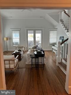 living area featuring a wealth of natural light, stairway, wood finished floors, and ornamental molding