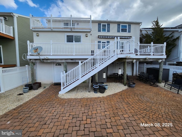 rear view of property featuring a patio area, fence, a deck, and stairs