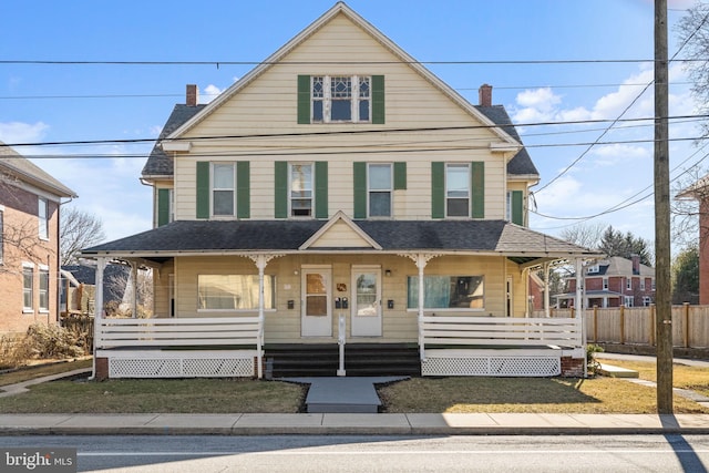 view of front of property with a chimney, a porch, a shingled roof, and fence