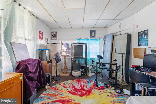 playroom featuring a drop ceiling and concrete floors