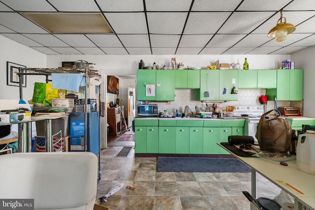 kitchen with a sink, stainless steel microwave, white electric stove, decorative backsplash, and a paneled ceiling