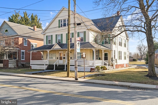 view of front facade with covered porch and a front lawn