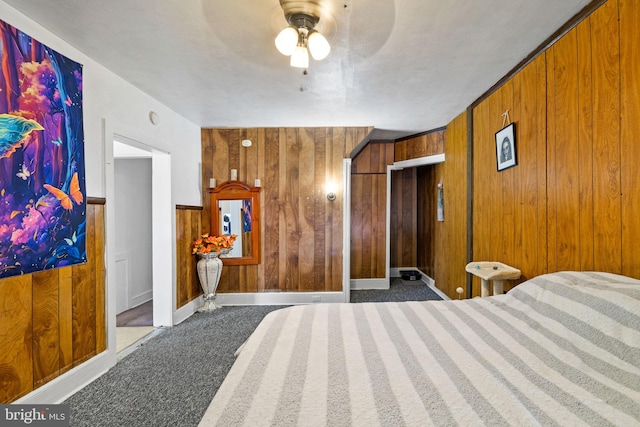 bedroom featuring wood walls and carpet floors