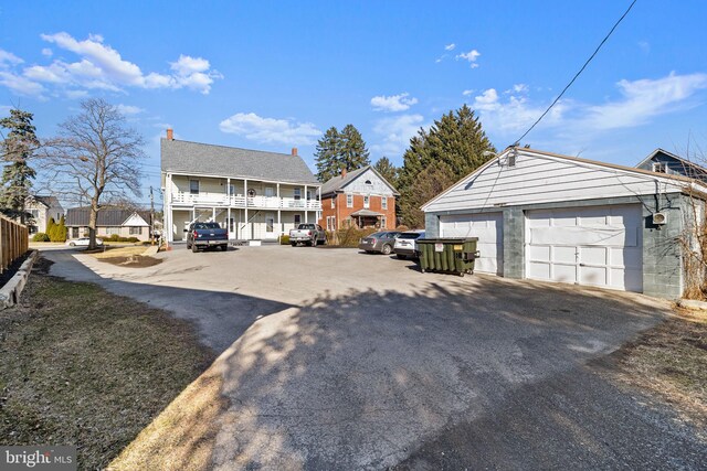 view of front of home featuring a detached garage and an outdoor structure