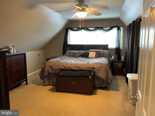 bedroom featuring vaulted ceiling, multiple windows, and carpet