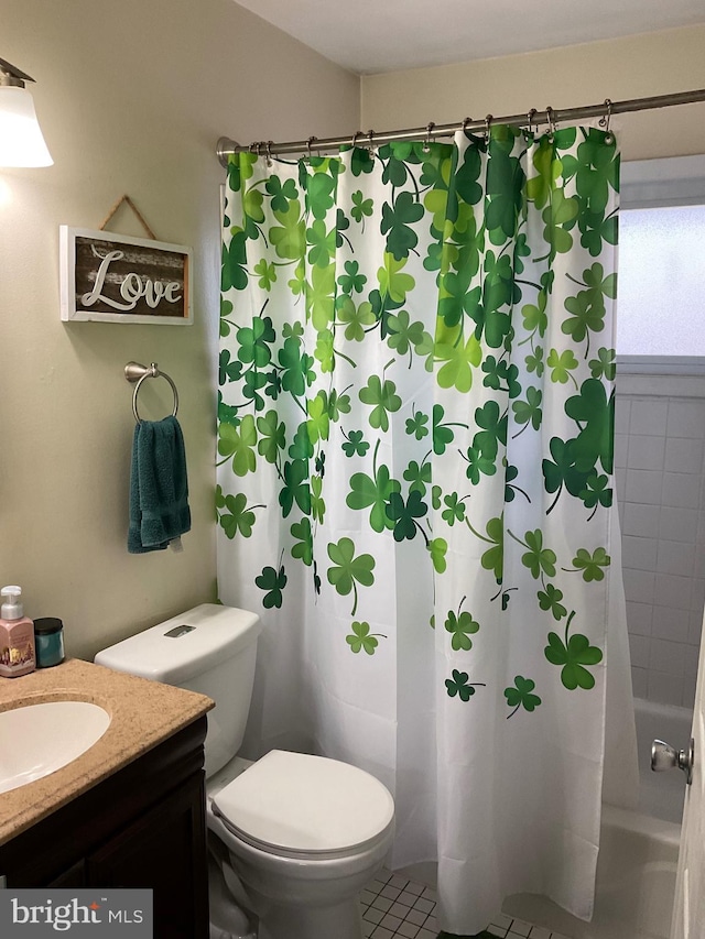 bathroom with toilet, tile patterned floors, and vanity