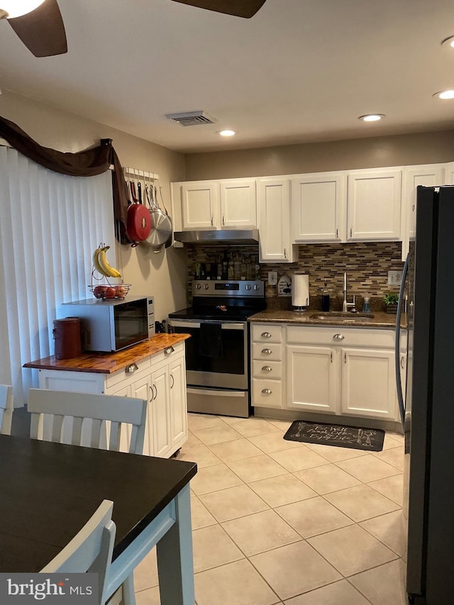 kitchen featuring stainless steel electric range, white cabinets, a sink, and black refrigerator