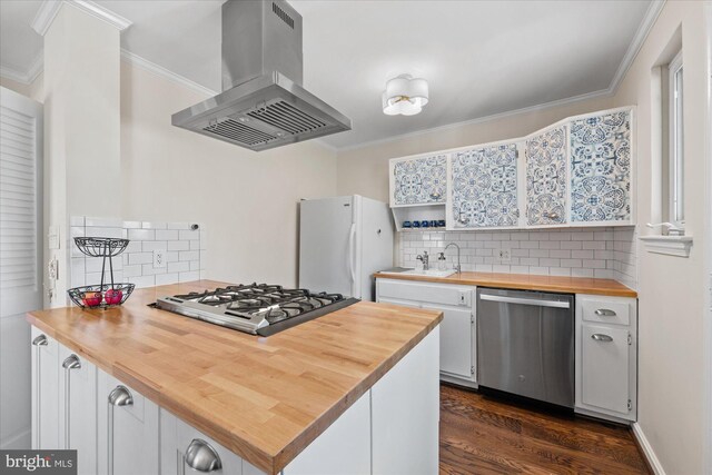 kitchen with island exhaust hood, dishwasher, cooktop, freestanding refrigerator, and butcher block countertops