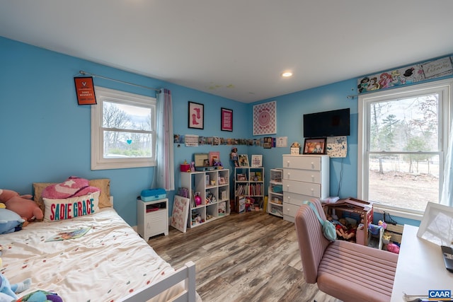 bedroom with multiple windows, wood finished floors, and recessed lighting