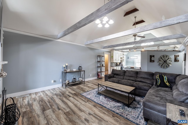 living area with vaulted ceiling with beams, ceiling fan, wood finished floors, visible vents, and baseboards