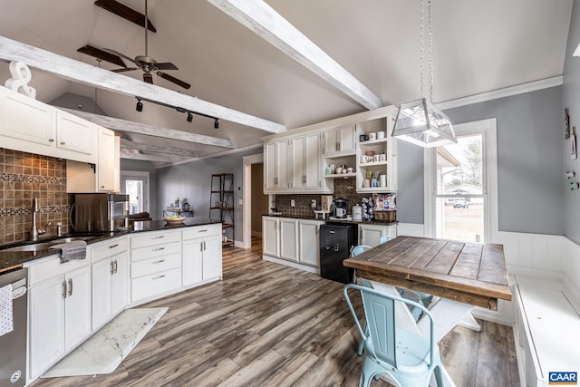 kitchen with open shelves, dark countertops, a sink, wood finished floors, and dishwasher