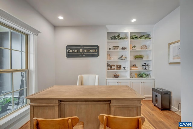 office area with light wood finished floors and recessed lighting