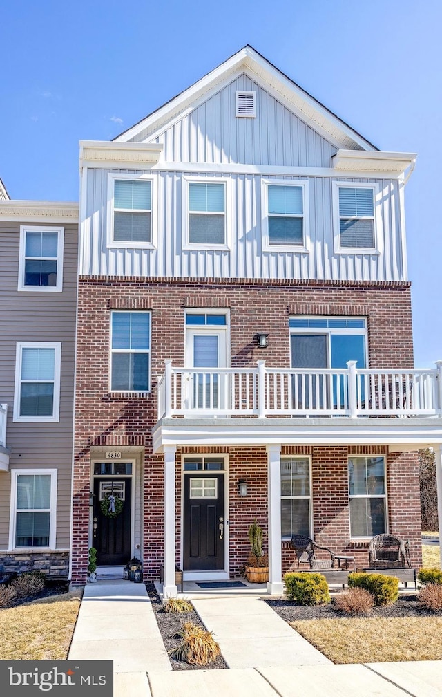 townhome / multi-family property featuring board and batten siding and brick siding