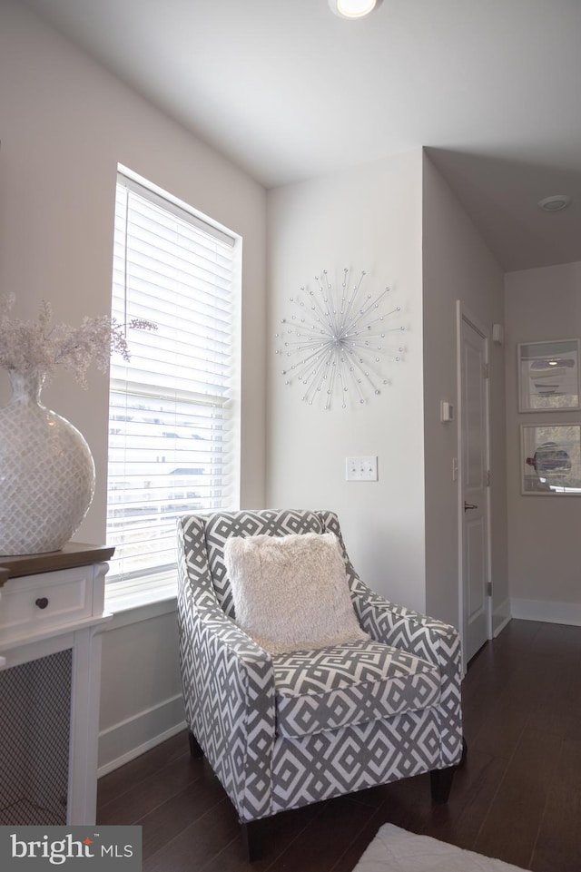 living area featuring wood finished floors and baseboards