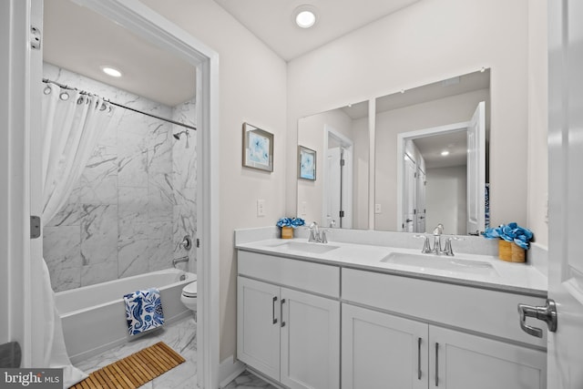 full bath with a sink, shower / tub combo with curtain, marble finish floor, and double vanity