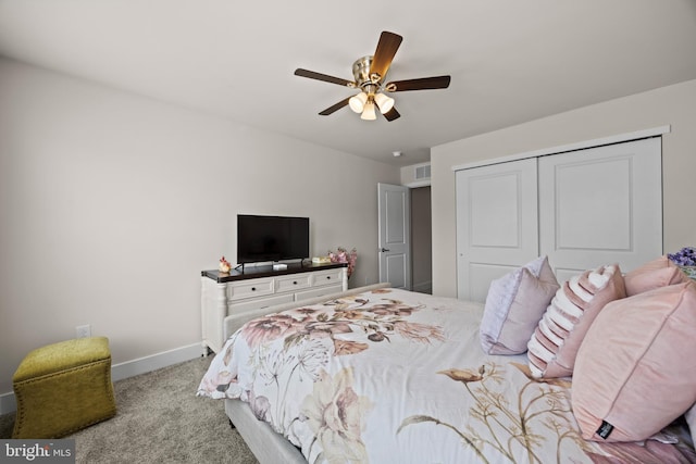 carpeted bedroom with baseboards, a closet, and ceiling fan