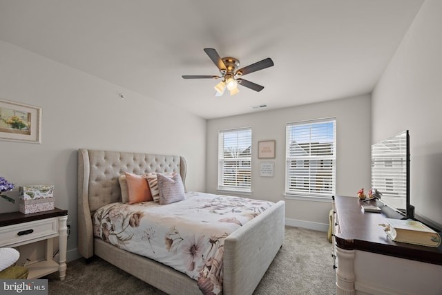 bedroom with visible vents, baseboards, light colored carpet, and a ceiling fan