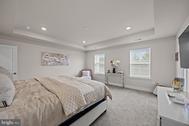 bedroom featuring visible vents, baseboards, carpet, a tray ceiling, and recessed lighting