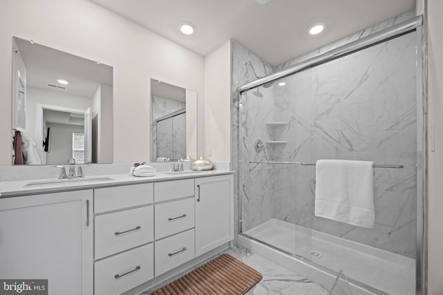 full bathroom with a sink, a marble finish shower, marble finish floor, and double vanity