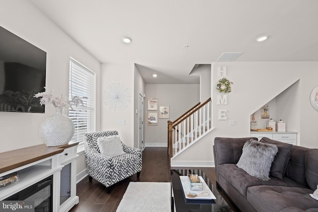 living area featuring stairs, recessed lighting, wood finished floors, and baseboards