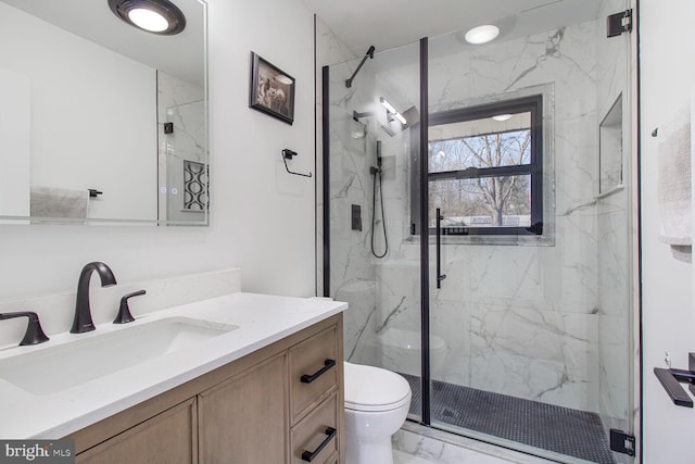 full bathroom with vanity, toilet, marble finish floor, and a marble finish shower