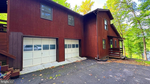 view of side of home with a garage and driveway