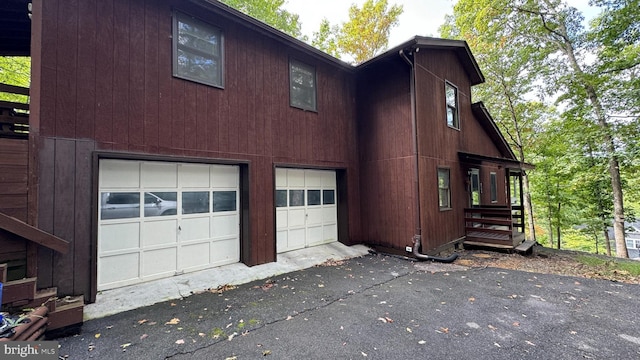 view of property exterior with a garage and driveway