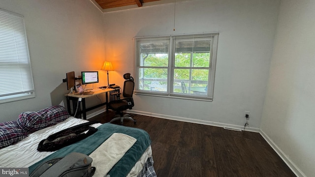 bedroom with baseboards and wood finished floors